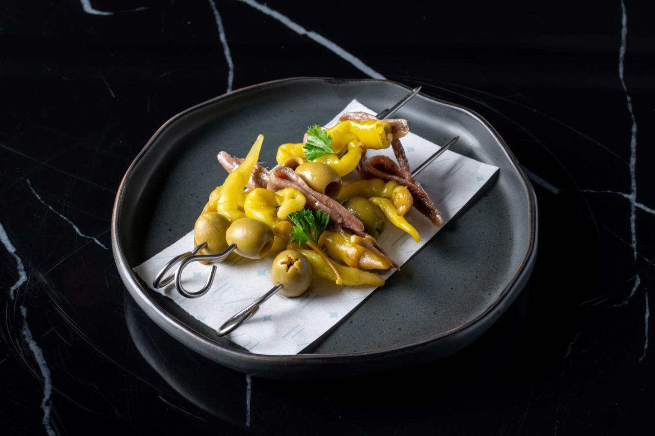 Innside By Melia Bangkok Sukhumvit Exterior photo A plate of grilled anchovies with peppers